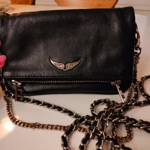 Zadig & Voltaire väska - Lyxig trendig och supersnygg väska i bra skick.     För fler bilder skriv om.  Höjd 11 cm Bredd 18 cm Axelband 127 cm  (Finns ett litet märke på baksidan men som inte syns )