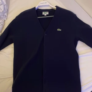 Lacoste cardigan - Fräsch stilren cardigan, bra till sena sommarkvällar! Bra skick knappt använd