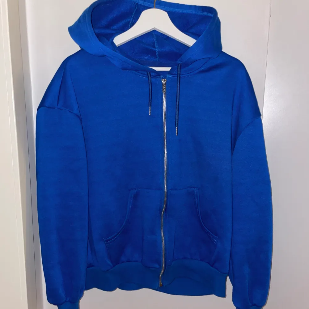Blå zip hoodie som bara använts ett fåtal gånger. Har inga defekter. Väldigt skön och har en stor huva.. Hoodies.