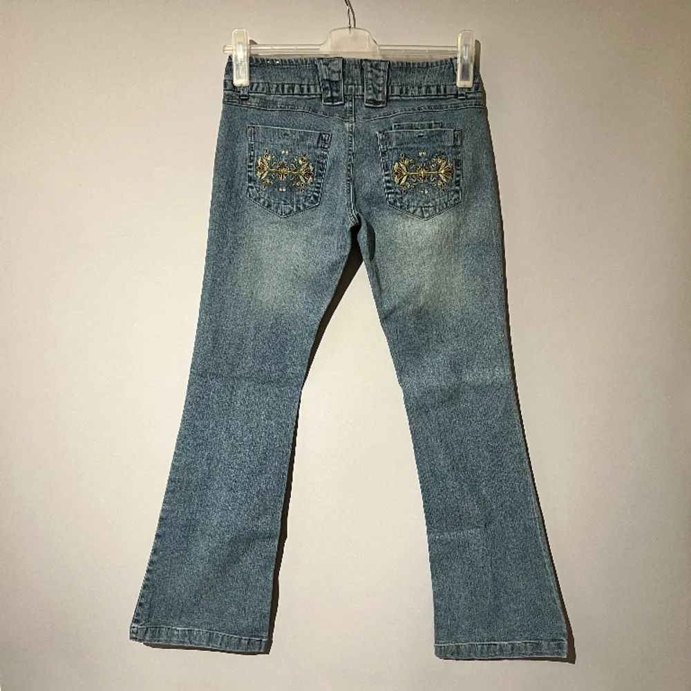 Ljusblå jeans i nästan helt nytt skick! 9/10.  Gult blommotiv på bakfixkorna.  Står size 5 som ungefär är W27. De är ca 39cm rakt över midjan och innerbensmåttet är ca 79cm. Frågor och prisförslag välkomnas.  18. Jeans & Byxor.
