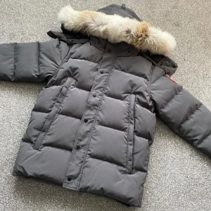 Canada Goose Wyndham Jacka - Köpt: Äkta och relativt ny (köpt för 6 700kr) nypris: 16000kr Skick: 9/10 använd fåtal gånger men för stor Skador: inga alls, som ny! Tillbehör ingår, frågor om mer bilder osv går att få😊