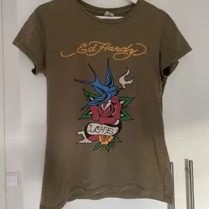 Jättecool khakifärgad edhardy t-shirt med tryck🕊️  Storleken är L men mer som en M  Har inga slitningar eller fläckar och är i ett bra skick Kontakta mig för frågor eller intresse 🖤🖤