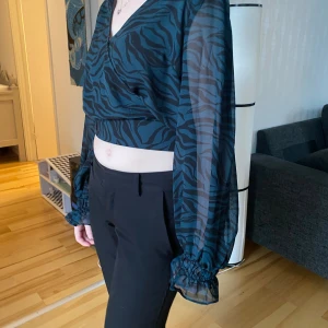 Crop-top/Blus strl 36 - Skitsnygg topp som är använd vid endast ett tillfälle så fint skick! Modellen är med knytning baktill och det är en kortare topp, som slutar strax ovanför naveln. 