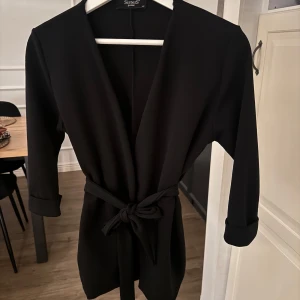 Svart kavaj från Sisters Point -  svart kavaj från Sisters Point med knytband i midjan. 