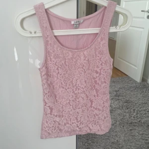 Rosa blommigt linne  - Fint rosa linne med blommiga detaljer på framsidan av linnet. Använd än gång.