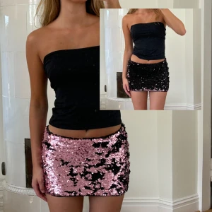 Svart och rosa paljettkjol - Minikjol med paljetter som skiftar mellan svart och rosa. Perfekt för fest! Från barnavdelningen strl 152, så typ XXS