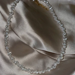 Elegant pärlhalsband - Säljer ett superchict pärlhalsband med vita pärlor. Perfekt för att ge en touch av elegans till vilken outfit som helst. Halsbandet har en klassisk design och passar både till vardags och fest. Ett måste för alla smyckesälskare! ✨