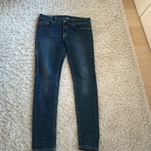 Blå jeans från Dondup - Snygga blå jeans från Dondup med en slim passform. Perfekta för en stilren look. De är i storlek 31 och jag säljer de för att det är för små. Skicket är 8,5/10 då de är använda ett fåtal gånger och har inga defekter. Priset är inte hugget i sten💯🙌🏼