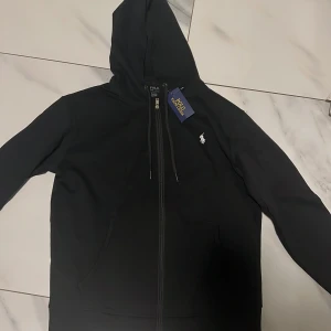 Svart hoodie från Ralph Lauren - Svart Ralph Lauren zip, mycket bra kvalite, helt oanvänd, inte äkta, storlek M
