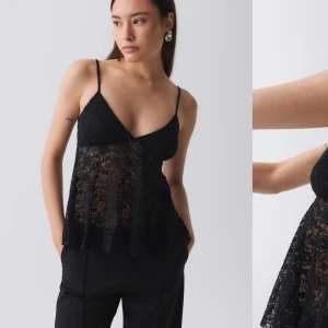 Svart spetslinne - Elegant svart spetslinne med smala axelband och v-ringning. Perfekt för en stilren och sofistikerad look.