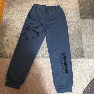 Blue anime pants - Blue anime pants with the letters handsom and an anime character called yoxi 