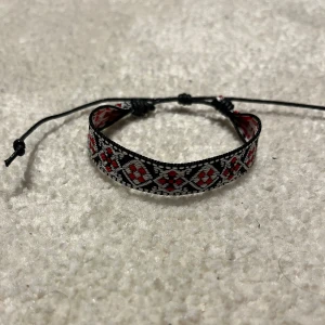 Flätat Armband  - Snyggt armband med justerbar snörning i svart och rött. Sprillans nytt och väldigt eftertraktat. Vid minsta fråga eller fundering hör av er🤝