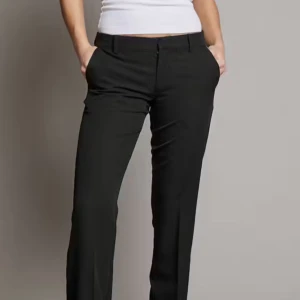 Svarta kostymbyxor - Snygga svarta kostymbyxor i normal passform. Perfekta för både kontoret och festliga tillfällen. De har en klassisk design men dragkedja och knappar. Byxorna är tillverkade i ett bekvämt material som ger en stilren look.