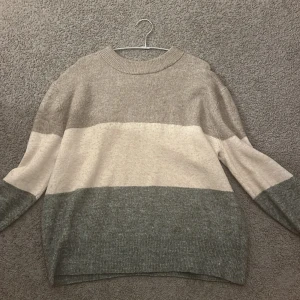 Beige och grå randig tröja från H&M - Mysig och stilren tröja från H&M i storlek M lite nopprig men går att fixa om man så vill 