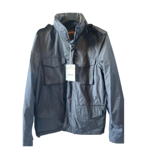 Svart jacka från Aspesi - Säljer en snygg svart jacka från Aspesi i nytt skick. Jackan fungerar både till höst och vinter | Jackan har även en luva som går att vika in i kragen | Nyrpis på denna jacka är ungefär 8000kr| Vid frågor är det bara att höra av sig 🙌