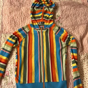 Retro hoodie kofta från ONLY - Säljer en färgglad randig hoodie från ONLY i storlek M. Tröjan har en dragkedja framtill och en mysig huva. Den är perfekt för att liva upp garderoben med sina livliga färger som blå, orange, gul och grön.  Stretchigt och mjukt tyg och älskar retro känslan men har inte använt på ett år :// Basically som ny även fast köpt second hand  🌈 