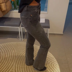 Grå bootcut jeans  - Snygga grå bootcut jeans med medel hög midja. 