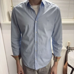 Ljusblå burberry skjorta  - Ljusblå burberry skjorta i storlek m! Väldigt bra skick på varan och passar till alla tillfällen. Bara att skriva vid funderingar!