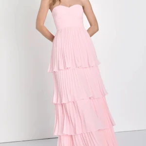 Rosa axelbandslös klänning - Elegant rosa axelbandslös klänning med plisserade volanger i flera lager. Perfekt för en somrig fest eller bal. Klänningen har en lång och flytande design som ger en romantisk känsla. Aldrig använd !!❤️