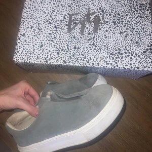 Grå sneakers från Eytys - Snygga grå sneakers från Eytys med en stilren design. Skorna har en tjock vit sula och är tillverkade i mocka. Perfekta för en avslappnad stil.