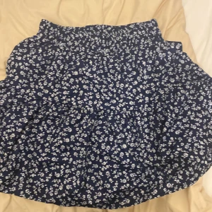 Blå kjol med vita blommor - Fin kjol, knappt använd. Från shein