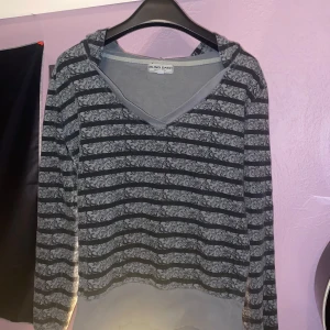 Grå och svart randig hoodie från Blind Date - Säljer en grå och svart randig hoodie från Blind Date. Den har ett unikt mönster i ränderna och en bekväm luva. V ringad och skit mysigt. Säljer för aldrig använt. Upplever storleken som M men XS,S och L kan också ha den 