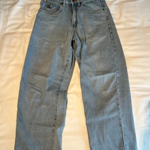 Butter Goods jeans  - Snygga blå jeans med en cool broderad detalj på bakfickan. De är slitna längst ner vid hälarna då dom är väl använda. Storlek W28