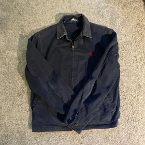 Ralph lauren jacka - Säljer en riktigt fet höstjacka av typen harrington från Ralph lauren. Riktigt snygg och ovanlig! Plagget är begagnat men saknar defekter så den ger ett mycket bra intryck. Perfekt övergångsjacka nu till hösten!
