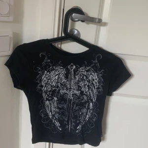 Svart t-shirt med tryck🖤 - Säljer nu denna från Minga london i strl M men skulle mer säga XXS-XS ment ganska stretchigt material. Nypris är ca 350kr så säljer denna för 110kr+frakt.