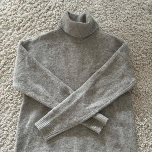 Grå polotröja från Pieces - Mysig grå polotröja från Pieces i storlek XS. Perfekt för kyliga dagar med sin mjuka och varma känsla. Tröjan har långa ärmar och en klassisk polokrage som håller dig varm och stilren. Passar perfekt till både vardag och lite finare tillfällen. 🧶