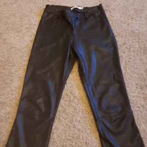 Svarta skinnbyxor från Carin Wester - Säljer ett par snygga svarta skinnbyxor från Carin Wester. De är i storlek 38 och har en stilren design med en tight passform. Perfekta för både fest och vardag! 🖤