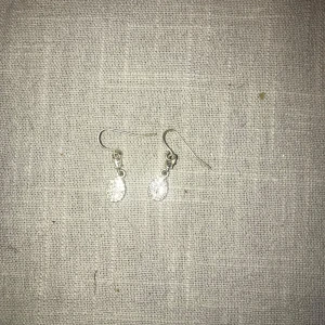 Glittriga silverörhängen - Snygga och eleganta örhängen i silver med glittrande droppformade hängen. Perfekta för att ge en touch av glamour till din outfit. Lätta att bära och passar till många tillfällen.