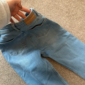 Blå jeans från Bershka - Snygga blå jeans från Bershka med klassisk femficksdesign och dragkedja. Perfekta för en avslappnad stil. De har en modern passform och är tillverkade i ett bekvämt denimtyg.