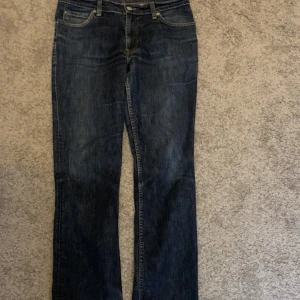 Levis jeans - Snygga mörkblå jeans från Levi's med klassisk femficksdesign och knappgylf. Perfekta för en avslappnad stil. De har en rak passform som ger en tidlös look. Pris kan diskuteras hör av er för frågor eller liknande!😁