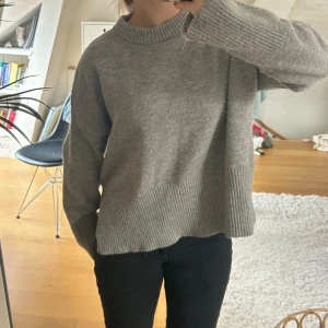 Grå stickad tröja - Använd ett par gånger mer än fortfarande mycket fin, har även slits på sidan💕