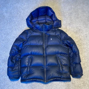 Polo Ralph lauren jacka - Säljer nu min polo Ralph lauren dunjacka som jag köpte förra vintern, pga för liten. Den är i bra skick förutom ett litet igensytt hål som man ser på sista bilden. Dm för mer info😀.