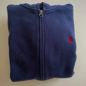 Ralph lauren zip - En sjukt snygg Ralph lauren zip hoodie som är perfekt till hösten. Säljer pga det inte längre passar. Passar folk som är 160-170cm. Har dock två små märken som har blivit lagade men som inte i övertaget knappast syns. Nypris 1100 kr