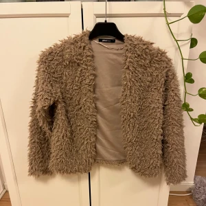 Fluffjacka/kofta - Superfin jacka/kofta i en fin brun färg, den är i stl S och köpt på Gina tricot. Verkligen superskönt material och håller värmen bra💕