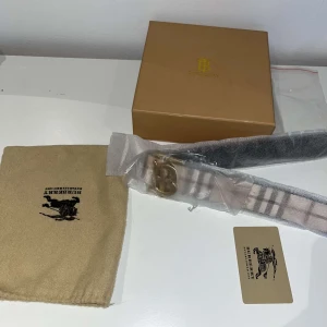 Rutig bälte från Burberry -  Ett stiligt och prisvärt bälte som kan användas på båda sidor. Den är helt ny och har bara använts tre gånger, och allt som syns på bilden ingår. Priset är förhandlingsbart.