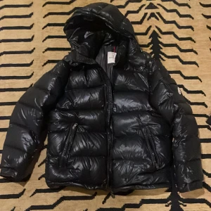 Moncler maya - Used but pretty good quality except the arm was little damaged. 