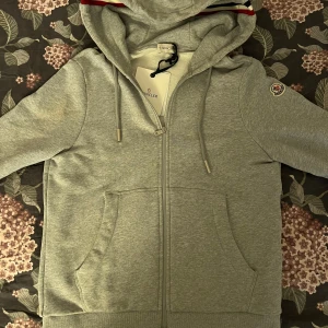 Moncler Zip Hoodie - Moncler Zip Up hoodie i nyskick! Endast använd enstaka gånger, marknadens absolut finaste kvalitet när det kommer till Moncler! Liten i storlek!! Garanterar hög kvalitet! Finns i Göteborg, kan självklart fraktas 🌟🙌🏻