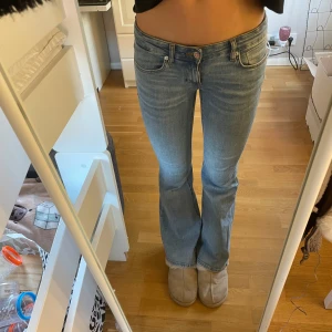 Blå bootcut jeans från Only - Snygga blå bootcut jeans från Only med låg midja. Perfekta för en avslappnad stil. Klassisk femficksdesign och knappgylf.