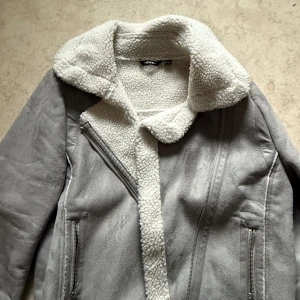 Grå teddyjacka från Esmara - Säljer en snygg grå teddyjacka från Esmara med mjukt foder och dragkedja. Jackan har en mysig krage och två praktiska fickor med dragkedjor. Perfekt för kyliga dagar! 🐻