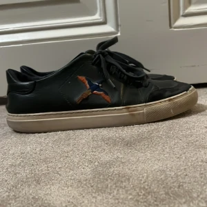 Axel arigato skor - Säljer mina axel arigato skor. De är lite trasiga på framsidan och på snöret annars är dem i bra skick. Hör av er för mer bilder.