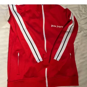 Röd Palm angels L - En röd Palm angels track top, i topp skick. Köpte den på PLiQ och endast testade den, den va för stor. Jätte fin kvalite, 