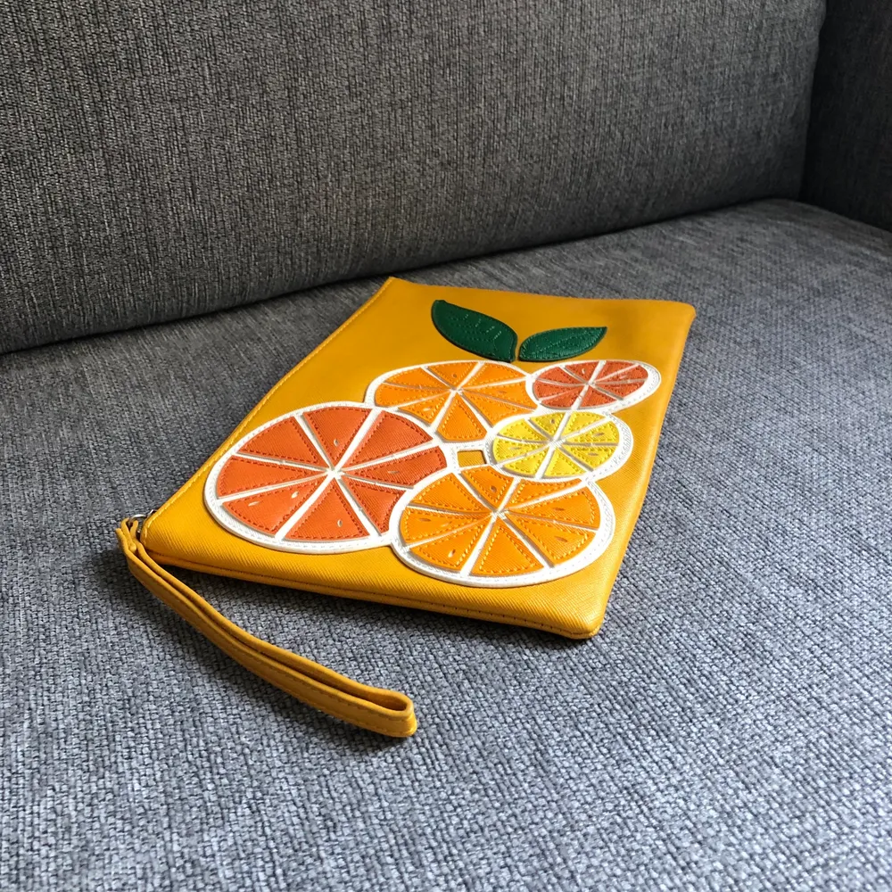 Orange clutch with tasty orange decoration from Mango. Make your outfit special! . Väskor.