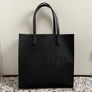 Ted Baker-väska - En rymlig väska, perfekt som exempelvis skolväska (bild tre för referens) då man får plats med flera böcker och block, men även pennskrin och vattenflaska. Köpt för två månader sedan på Zalando för 600 kr och använd ytterst fåtal gånger, så i princip nyskick. 450 kr inkl. spårbar frakt 