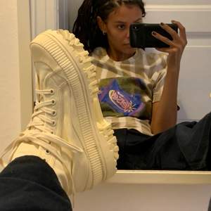 Creme colored high top canvas sneakers. Never worn