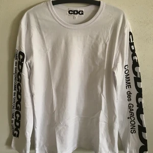Comme Des Garçons Logo Long Sleeve Tee - CDG / Comme Des Garçons Arm Logo Long Sleeve T-Shirt  Size large, fits like a regular men’s size medium.  Excellent condition, no flaws or damage.  DM if you need exact size measurements.   Buyer pays for all shipping costs. All items sent with tracking number.   No swaps, no trades, no offers. 