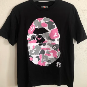 Women’s Bape Pink Camo Head Tee - Women’s Bape / A Bathing Ape Pink Camo Head T-Shirt  Size small, women’s fit.  Great condition, no flaws or damage.  DM if you need exact size measurements.   Buyer pays for all shipping costs. All items sent with tracking number.   No swaps, no trades, no offers.  